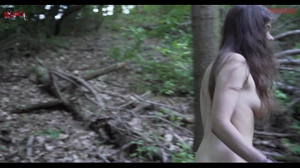 Mel walks naked in the wood