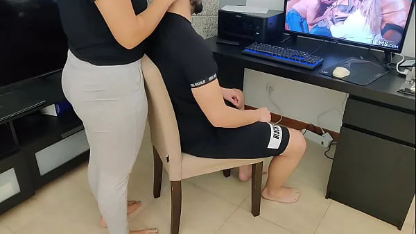 mature gives her stepson a handjob while watching porn